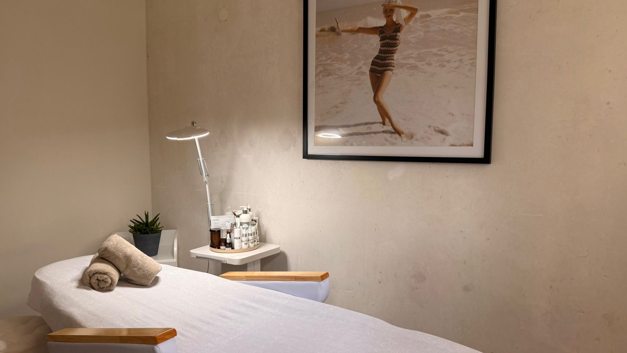 Moments treatment room with treatment bed and wall portrait